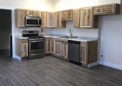 Our live/work suite offers a full kitchen with gorgeous hickory cabinetry